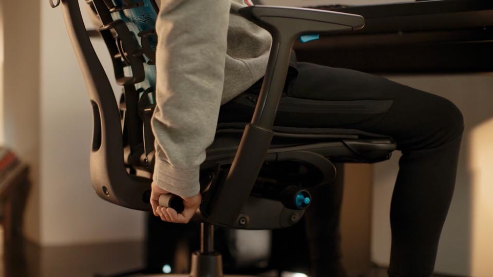 Un vídeo en primer plano de la mano de una persona ajustando el Backfit de una silla para videojuegos Embody negra.